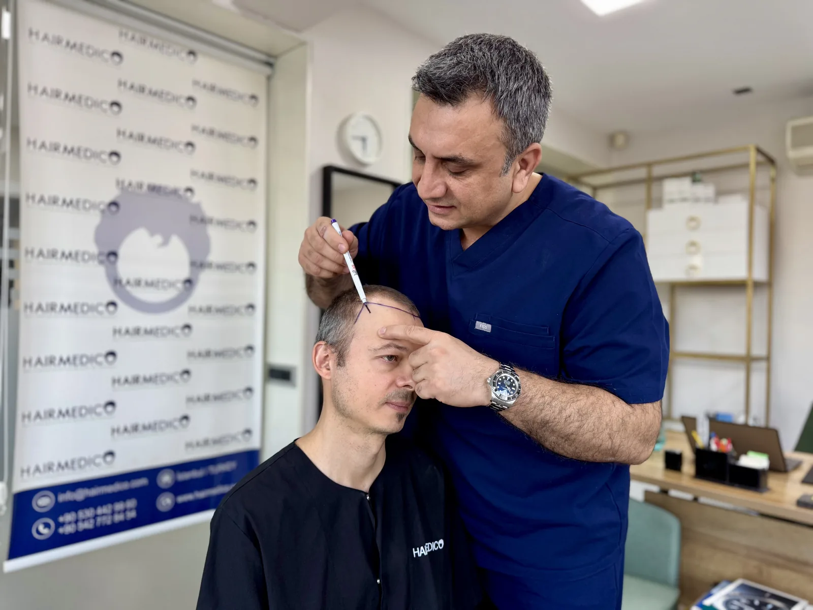 Dr. Arslan Musbeh planning a hairline design and graft count with a patient at Hairmedico Istanbul