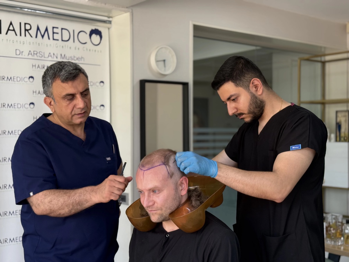 Dr. Arslan Musbeh and the Hairmedico surgical team planning a hairline design