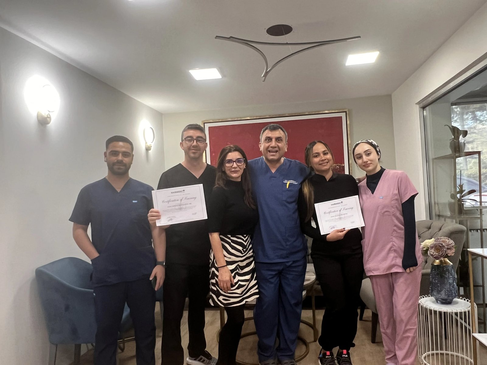 Hairmedico team with a patient in the clinic patient area